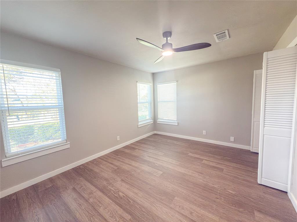 2431 Marfa Avenue Dallas, TX 75216 - Photo 28 of 39 a view of an empty room with wooden floor and a window
