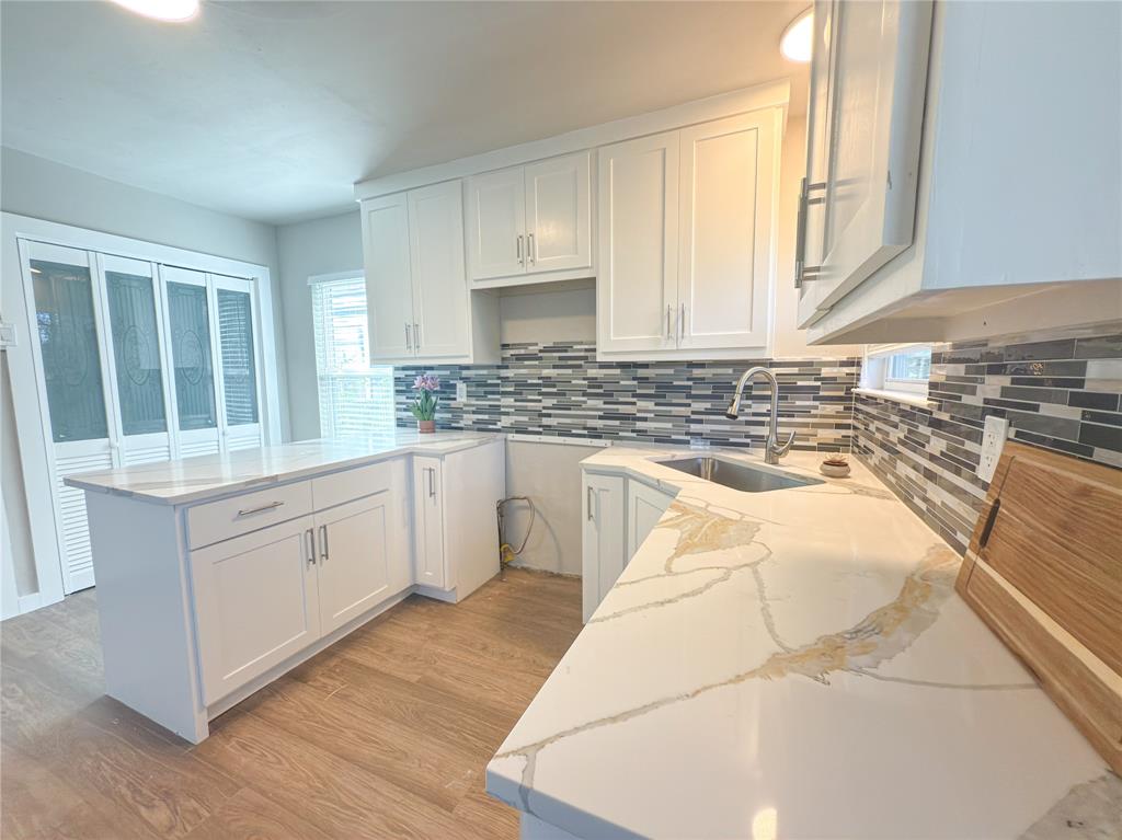 2431 Marfa Avenue Dallas, TX 75216 - Photo 7 of 39 a kitchen with stainless steel appliances granite countertop a stove a sink and a microwave