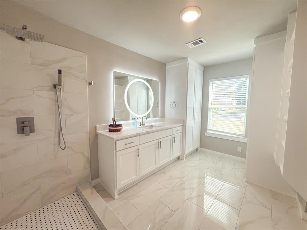 2431 Marfa Avenue Dallas, TX 75216 - Photo 10 of 39 a bathroom with a double vanity sink a mirror and a
