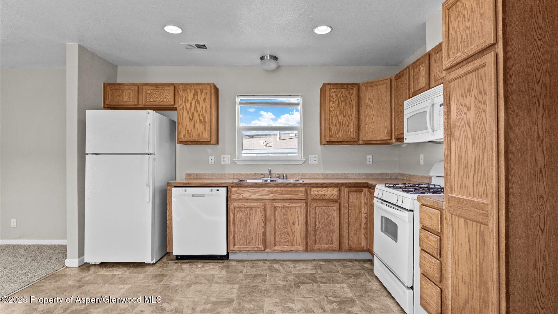 58 Logans Lane Parachute, CO 81635 - Photo 12 of 25 a kitchen with stainless steel appliances granite countertop a refrigerator sink and stove