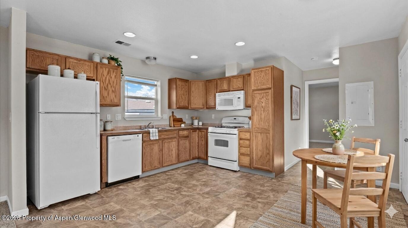 58 Logans Lane Parachute, CO 81635 - Photo 10 of 25 a kitchen with refrigerator a microwave a stove top oven and refrigerator