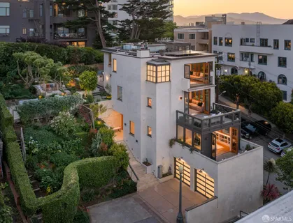 an aerial view of multiple houses with a yard