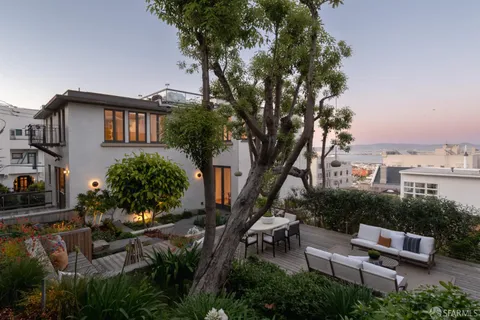 a view of a backyard with chairs and a fire pit