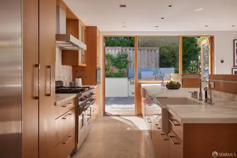 a view of a dining room with furniture and a floor to ceiling window