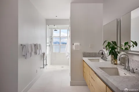 a bathroom with a window and a shower