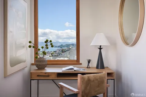 a bedroom with a large bed and a couch next to a window