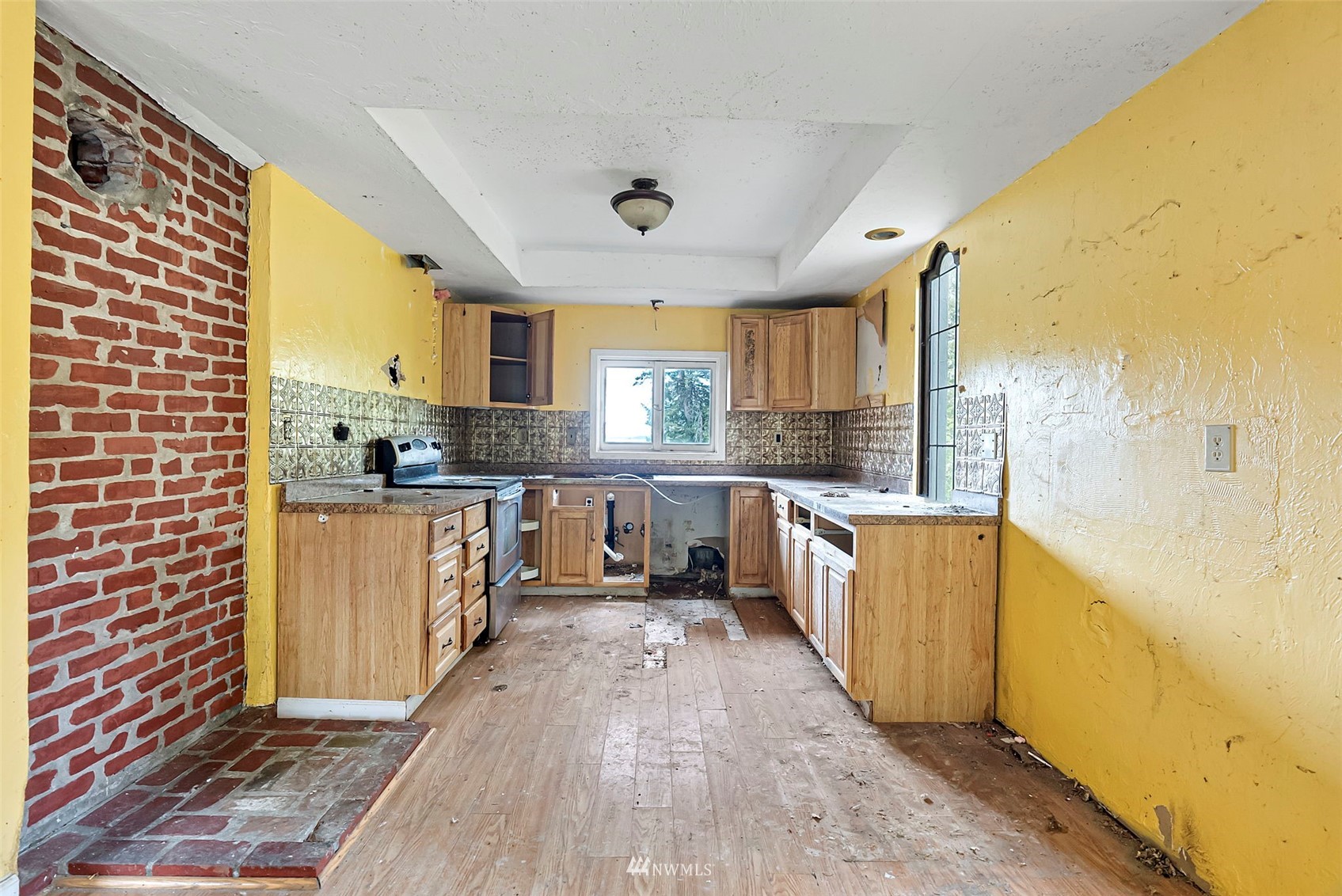 16601 Delano Road Southwest Lakebay, WA 98349 - Photo 11 of 31 a large kitchen with stainless steel appliances a large counter top a stove a sink and a refrigerator