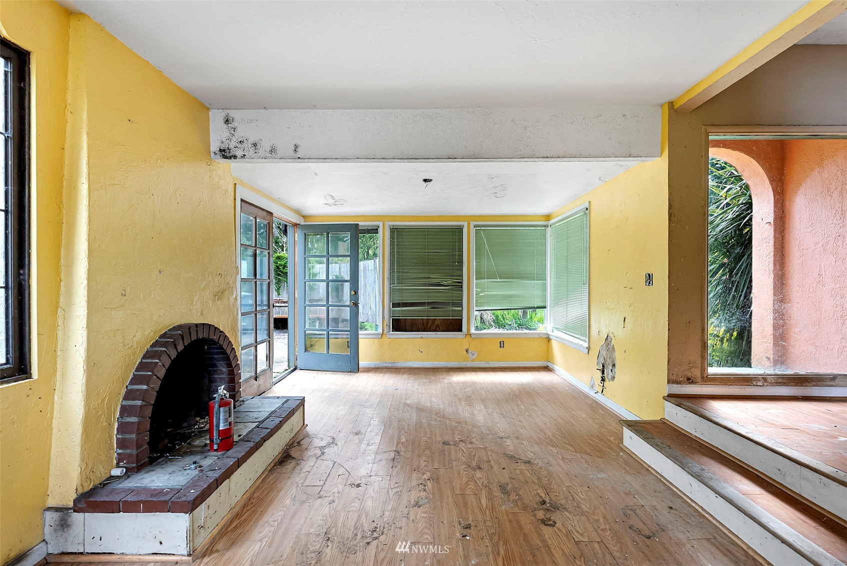 16601 Delano Road Southwest Lakebay, WA 98349 - Photo 12 of 31 a bedroom with a bed and a large window