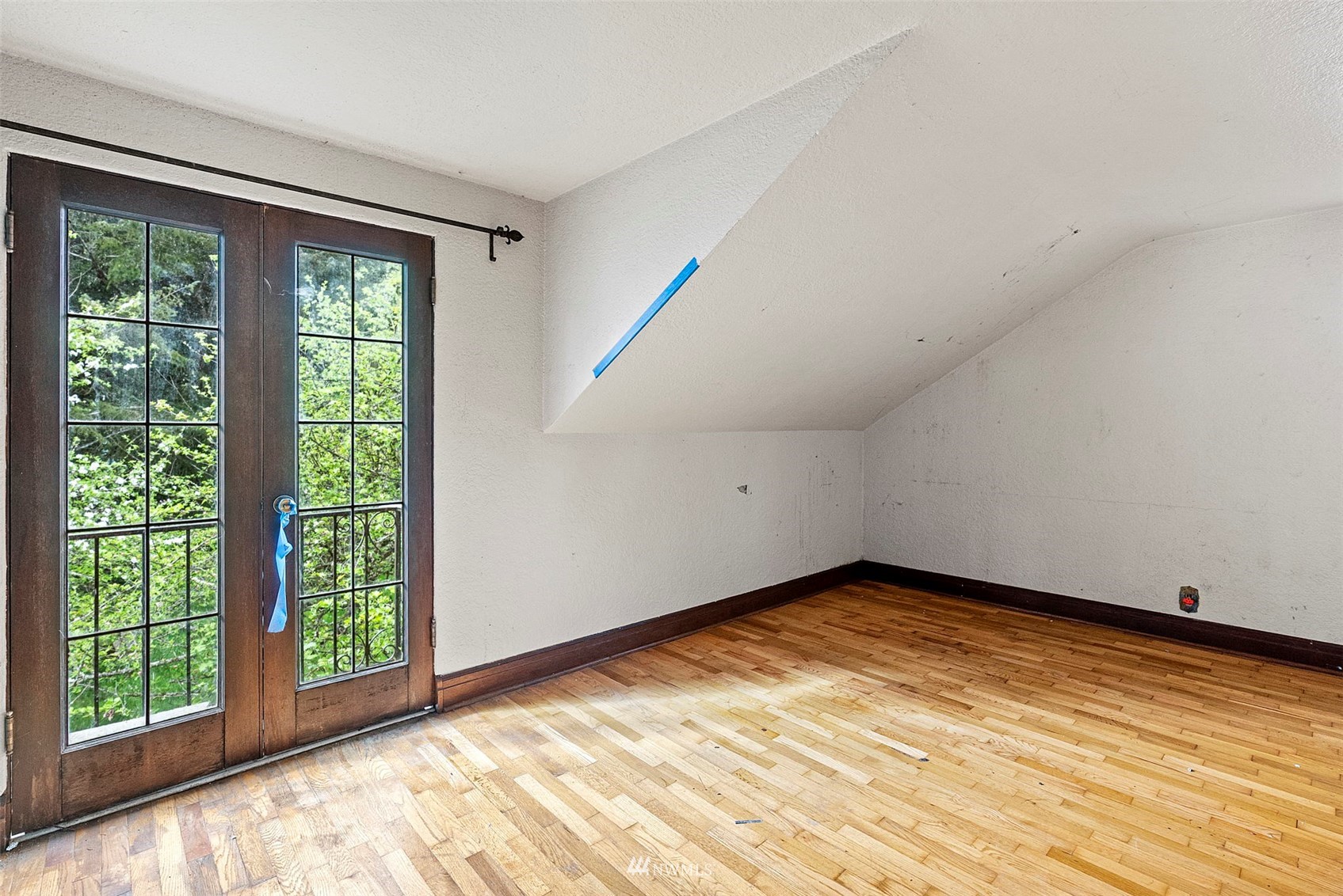 16601 Delano Road Southwest Lakebay, WA 98349 - Photo 22 of 31 a view of an empty room with wooden floor and a window