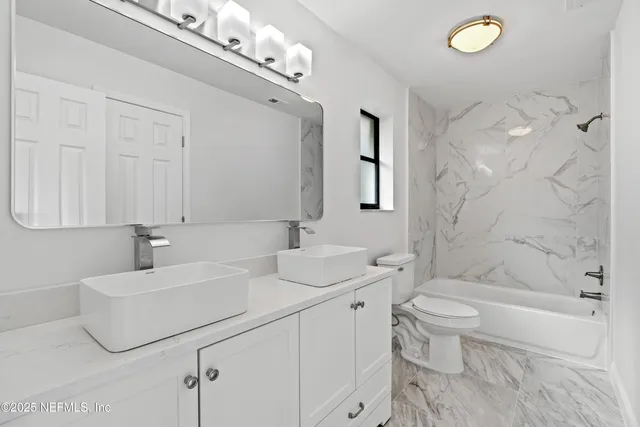 a view of a dining room with furniture and window