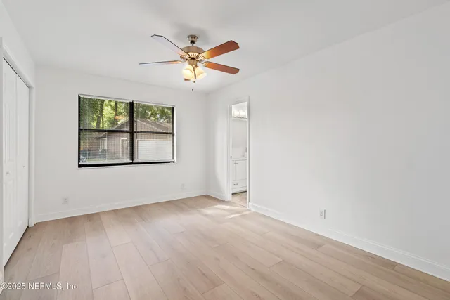 a view of a hallway with wooden shelves