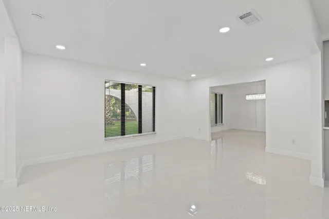 a view of an empty room with a fireplace