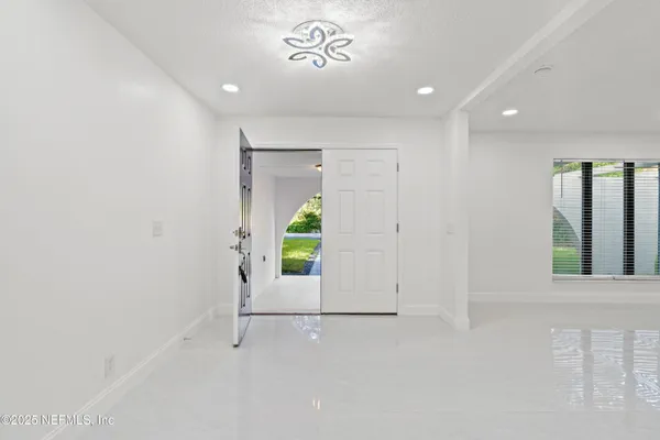 a view of an empty room with a fireplace