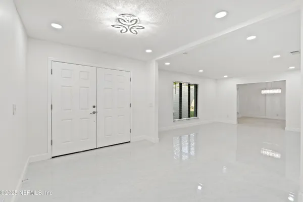 a view of a livingroom with furniture fridge and windows