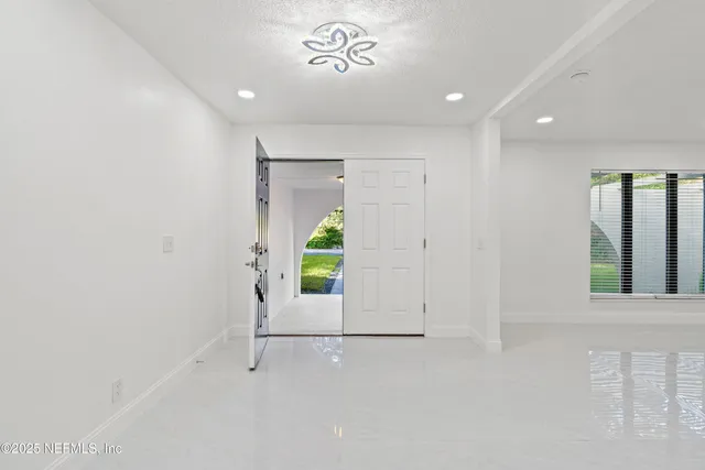 a view of a livingroom with furniture fridge and windows