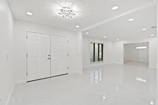 a spacious bathroom with a double vanity sink mirror and bathtub