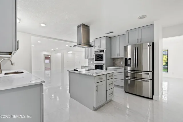 a view of a livingroom with a ceiling fan and wooden floor