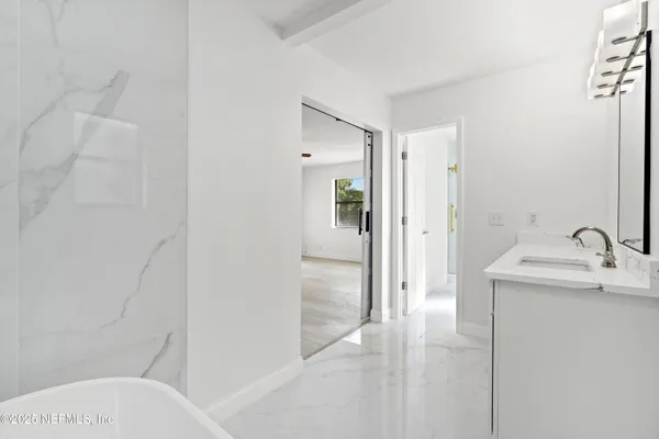 a view of green field with tree in the background