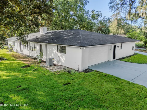 an aerial view of a house with a yard
