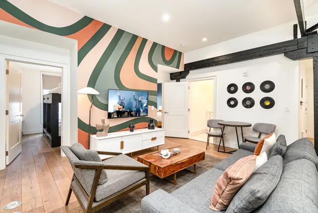 a living room with furniture and wooden floor