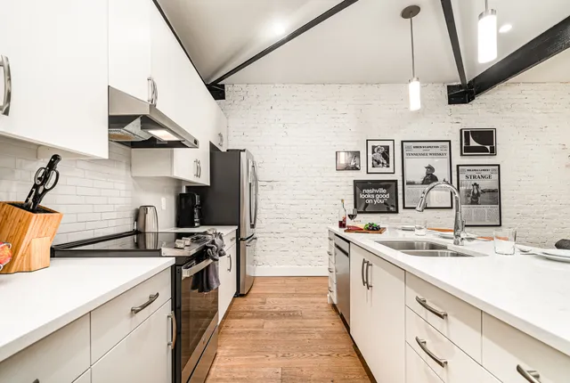 a kitchen with stainless steel appliances granite countertop a sink and a stove