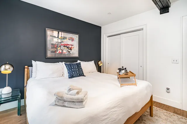 a bedroom with bed and cupboard