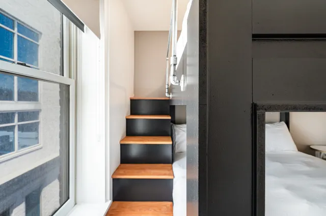 a bedroom with a large bed and a large window