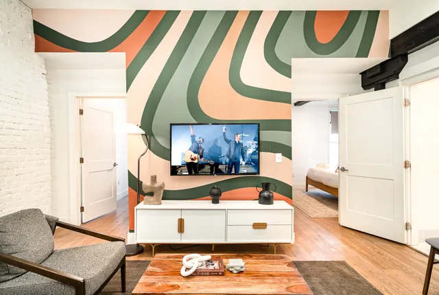 a living room with furniture and a wooden floor