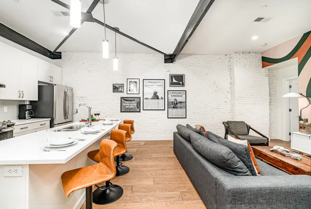 a living room with furniture and flat screen tv