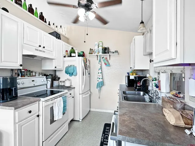 a kitchen with stainless steel appliances kitchen island granite countertop a lot of cabinets a washer and dryer