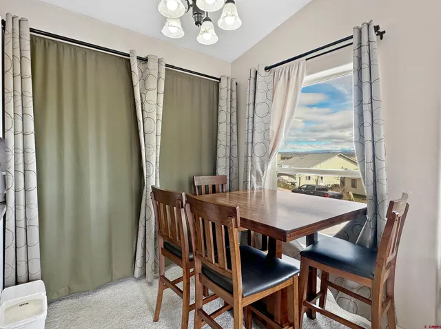 a dining room with furniture and window