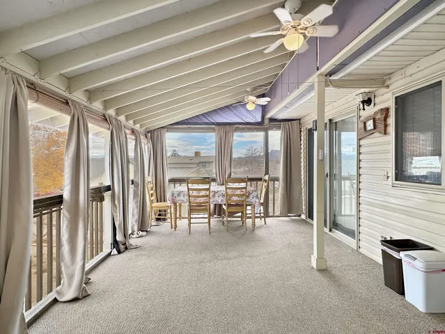 a dining room with furniture and a chandelier