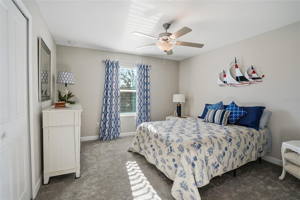 1370 White Fox Run Lutz, FL 33549 - Photo 24 of 49 a bedroom with a bed and a chandelier