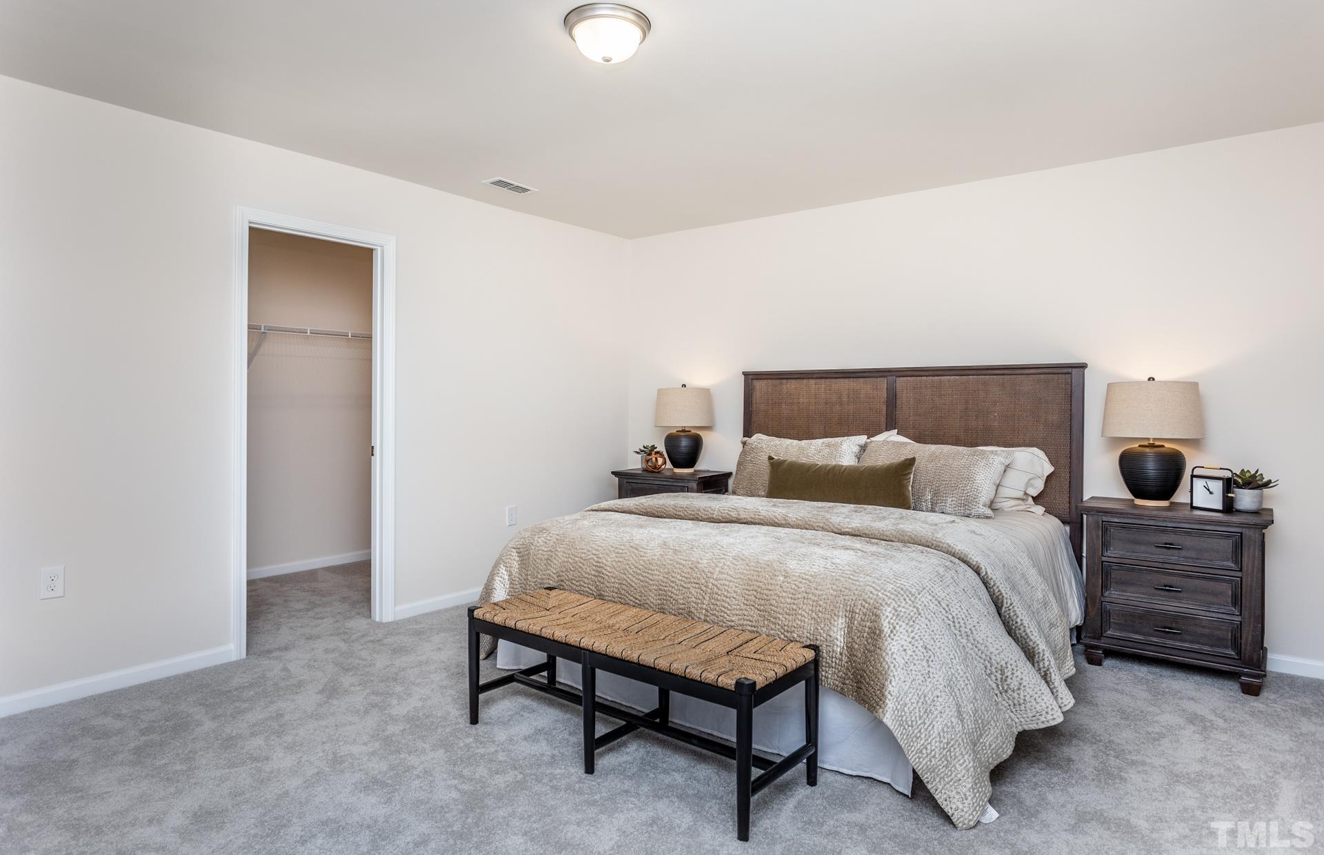 3505 Dragonfly River Court Raleigh, NC 27604 - Photo 15 of 28 a spacious bedroom with a bed and cabinets