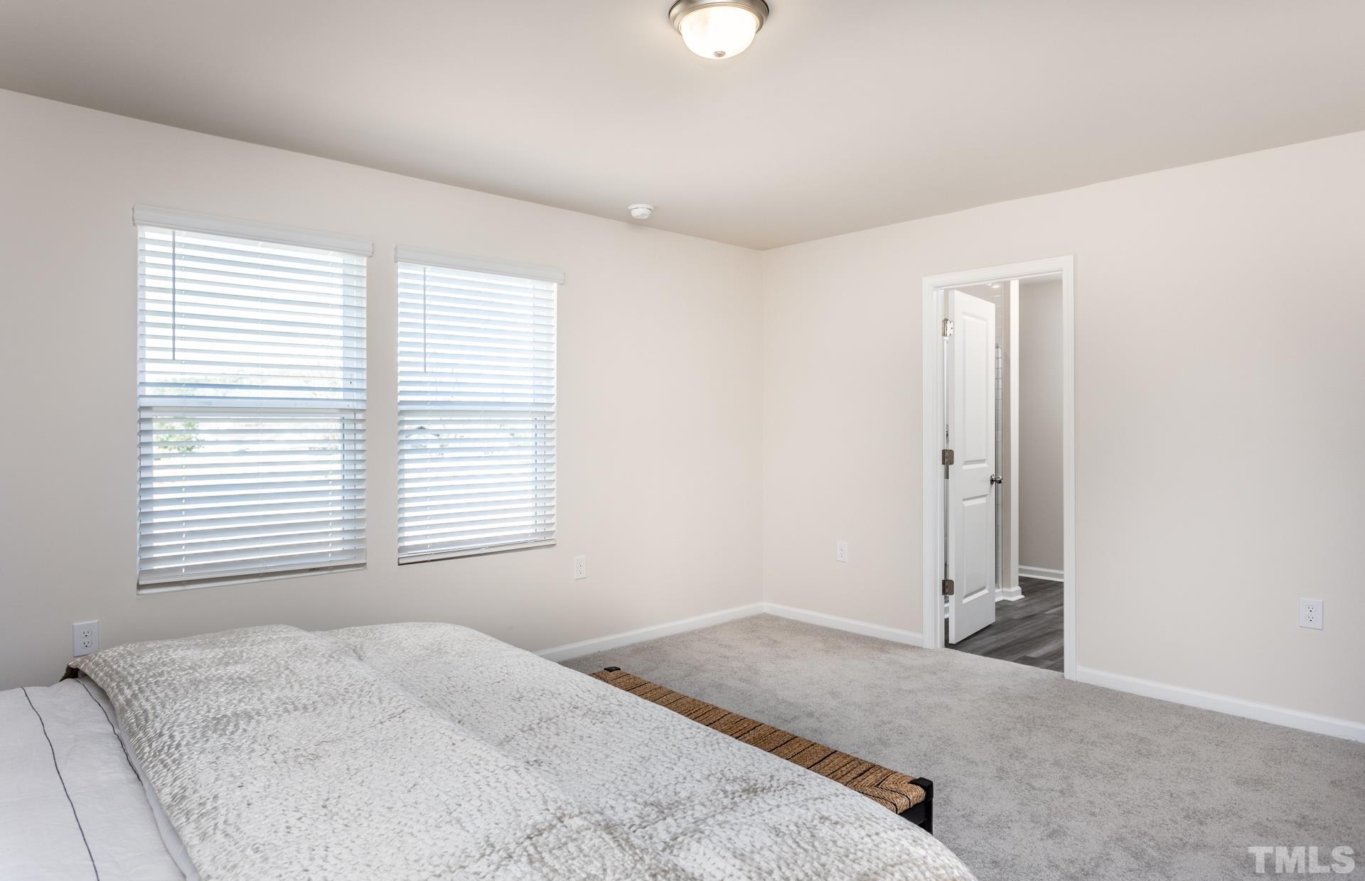 3505 Dragonfly River Court Raleigh, NC 27604 - Photo 18 of 28 a bedroom with a bed and a window