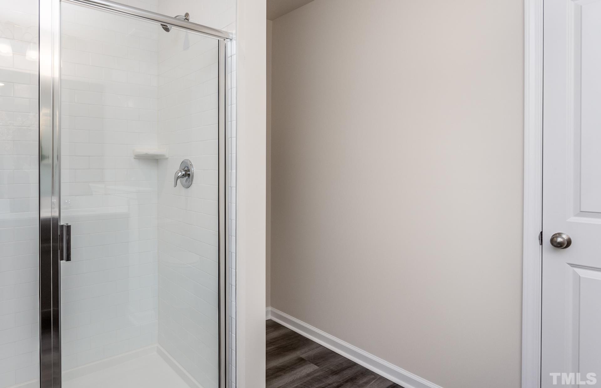 3505 Dragonfly River Court Raleigh, NC 27604 - Photo 22 of 28 a bathroom with a glass shower door
