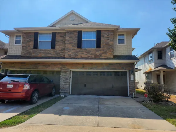a front view of a house with parking space