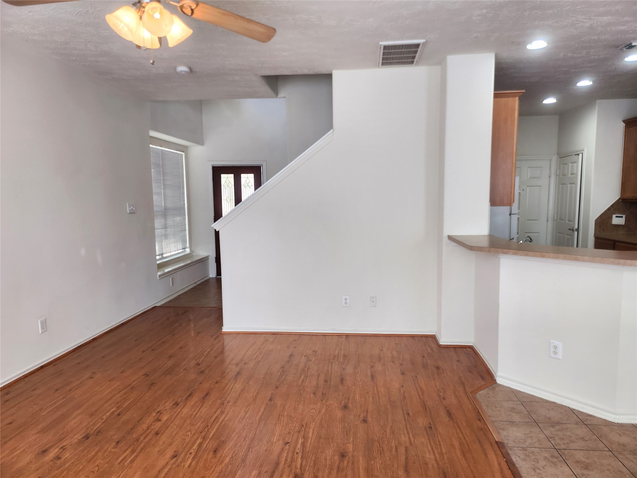 11509 Hackmatack Way Houston, TX 77066 - Photo 3 of 16 wooden floor in an empty room with a window