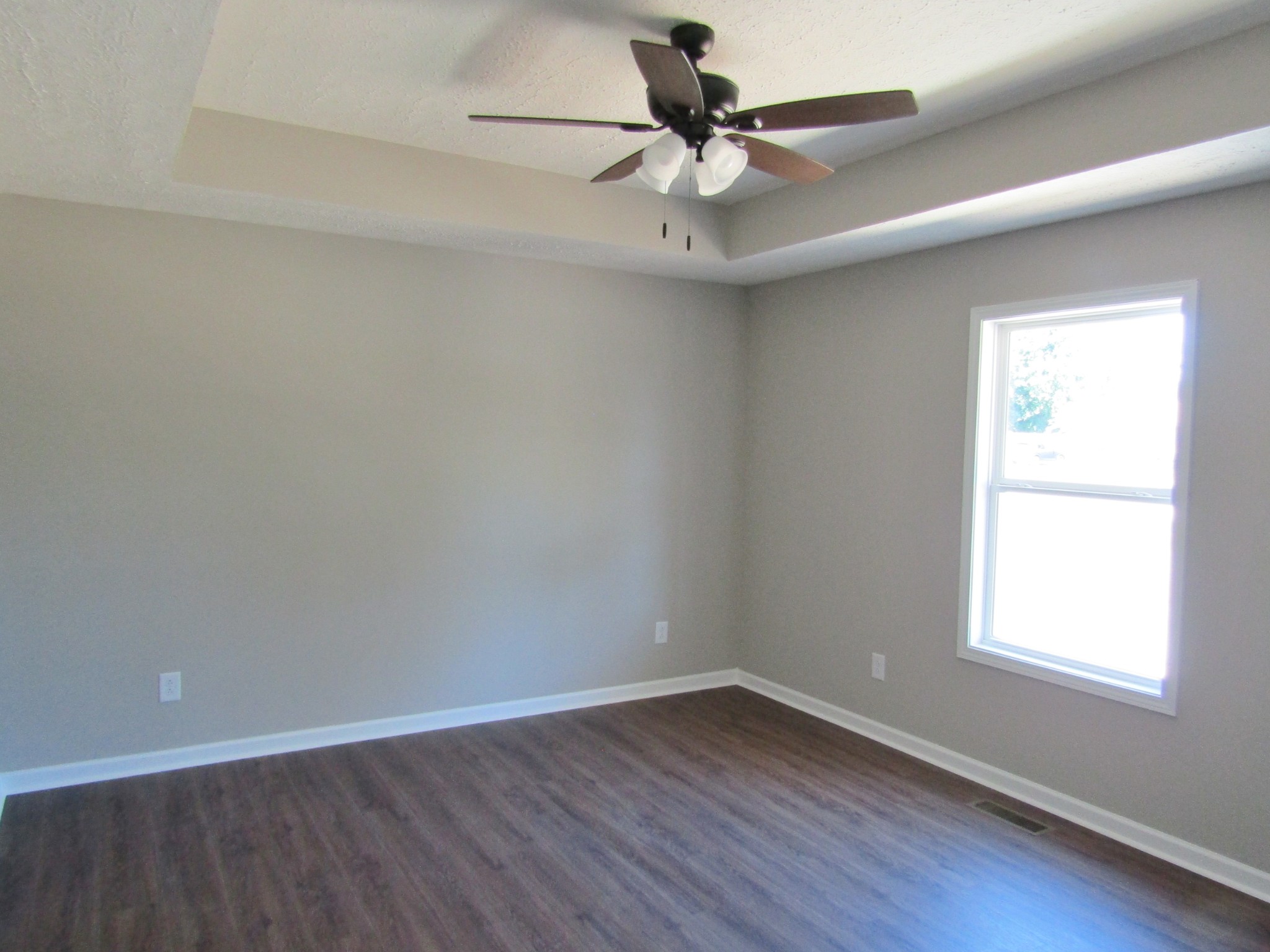 480 Crescent Factory Road Lawrenceburg, TN 38464 - Photo 9 of 14 an empty room with a window and a fan