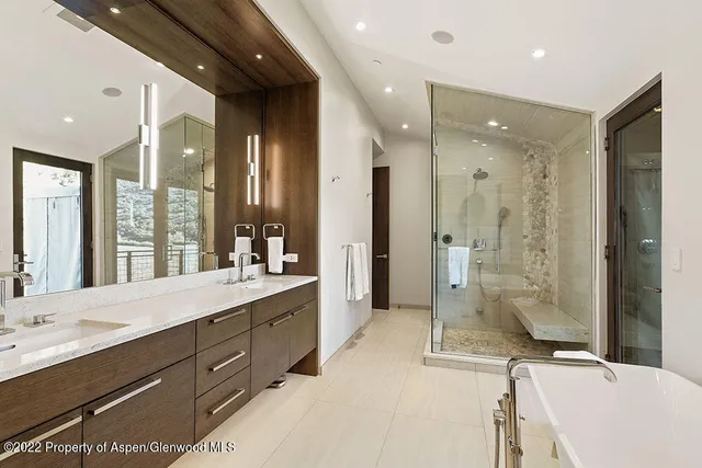a bathroom with a sink mirror and toilet