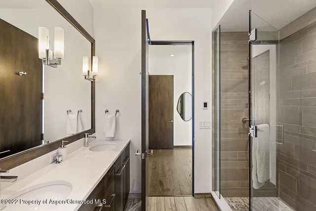 a bedroom with a bed and glass window