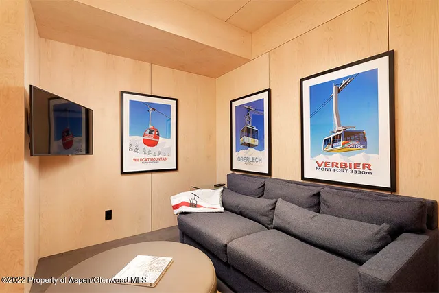 a living room with furniture and a wall painting