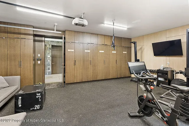 a view of a livingroom with workspace and a window