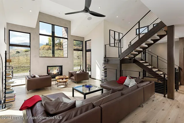 a living room with lots of furniture and white walls