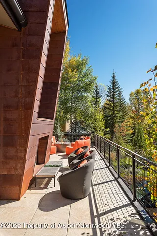 a living room with furniture large window and flat screen tv