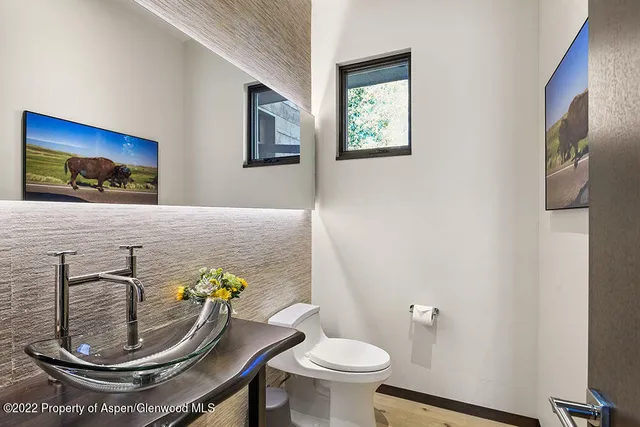 a kitchen with a stove a sink dishwasher and a dining table with cabinets