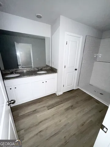 a kitchen with granite countertop a sink and a stove top oven