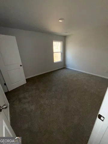 a view of an empty room and a window