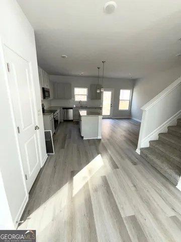 a view of a living room with fireplace and wooden floor