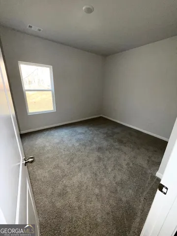 a view of an empty room and a window